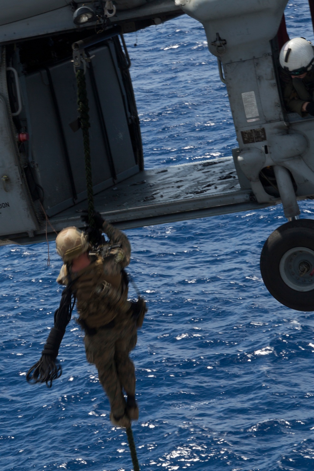 Recon Marines fast rope from an MH-60S aboard the USS Wasp