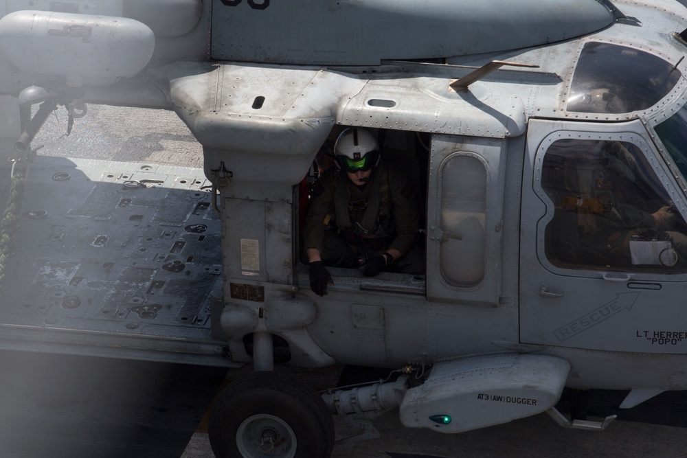 Recon Marines fast rope from an MH-60S aboard the USS Wasp