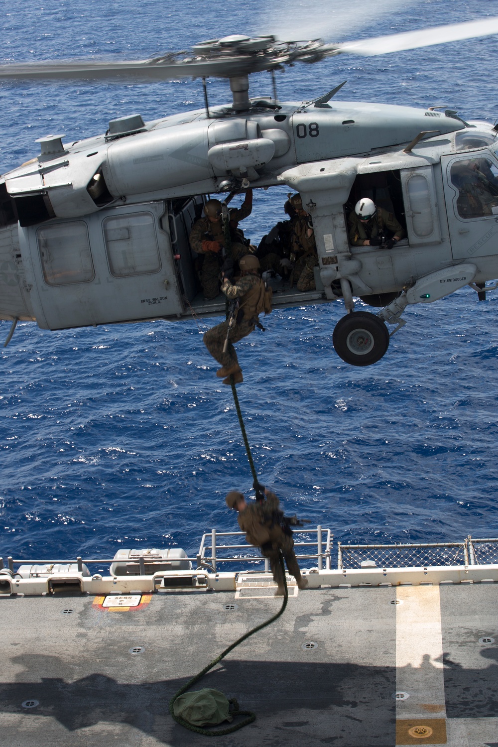 Recon Marines fast rope from an MH-60S aboard the USS Wasp