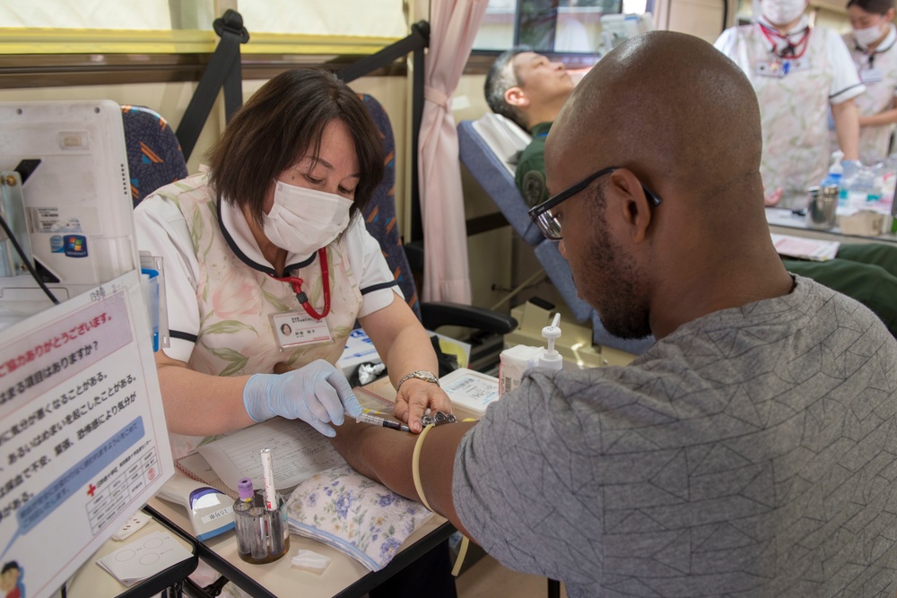 Members of Team Yokota donate blood to JRCS