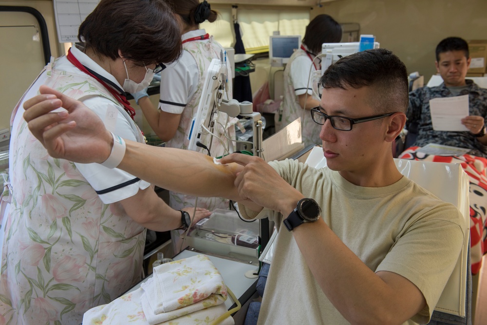 Members of Team Yokota donate blood to JRCS