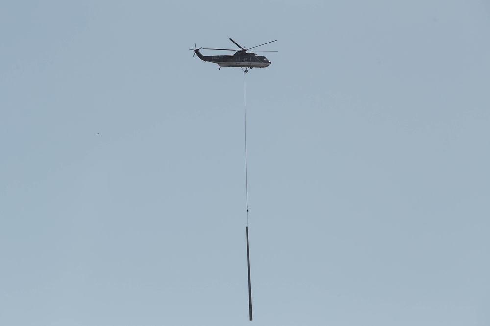 Helicopter Delivers Poles To Re-establish The Power Grid