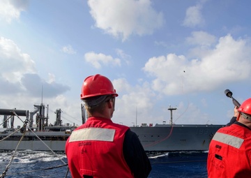 Chief Gunner’s Mate fires a shot line from USS Mustin (DDG 89) to USNS Walter S. Diehl (T-AO-193) during a replenishment-at-sea