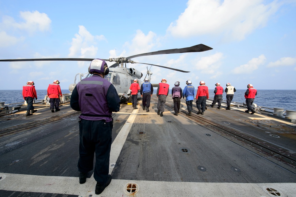 Sailors from USS Mustin (DDG 89)perform foreign object and debris (FOD) walk down