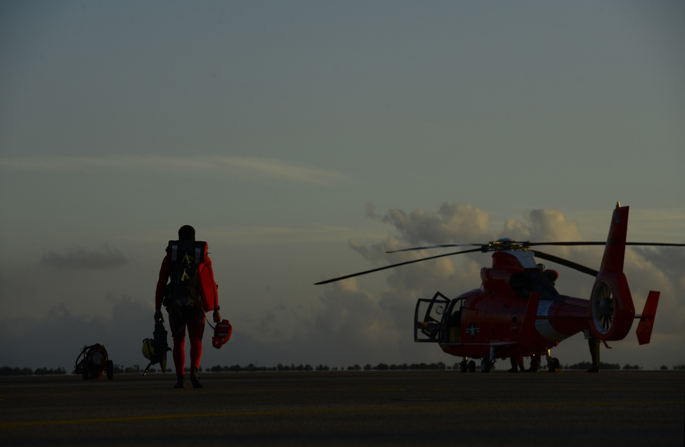 Coast Guard rescue swimmer boards helicopter