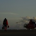 Coast Guard rescue swimmer boards helicopter