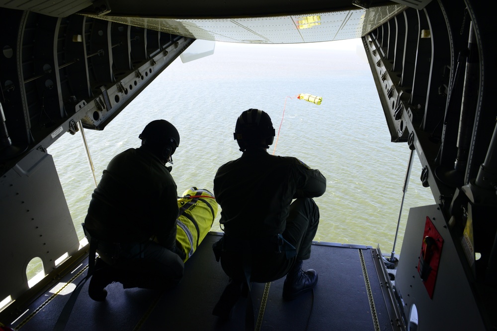 Coast Guard members drop cargo to vessel