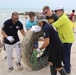 Task Force Spartan Soldiers join embassy staff, concerned citizens in beach cleanup