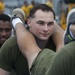 Marines and Sailors PT on the flight deck of the USS Wasp