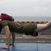 Marines and Sailors PT on the flight deck of the USS Wasp