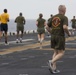 Marines and Sailors PT on the flight deck of the USS Wasp