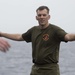 Marines and Sailors PT on the flight deck of the USS Wasp