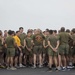 Marines and Sailors PT on the flight deck of the USS Wasp