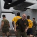 Marines and Sailors PT on the flight deck of the USS Wasp