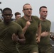 Marines and Sailors PT on the flight deck of the USS Wasp