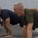 Marines and Sailors PT on the flight deck of the USS Wasp