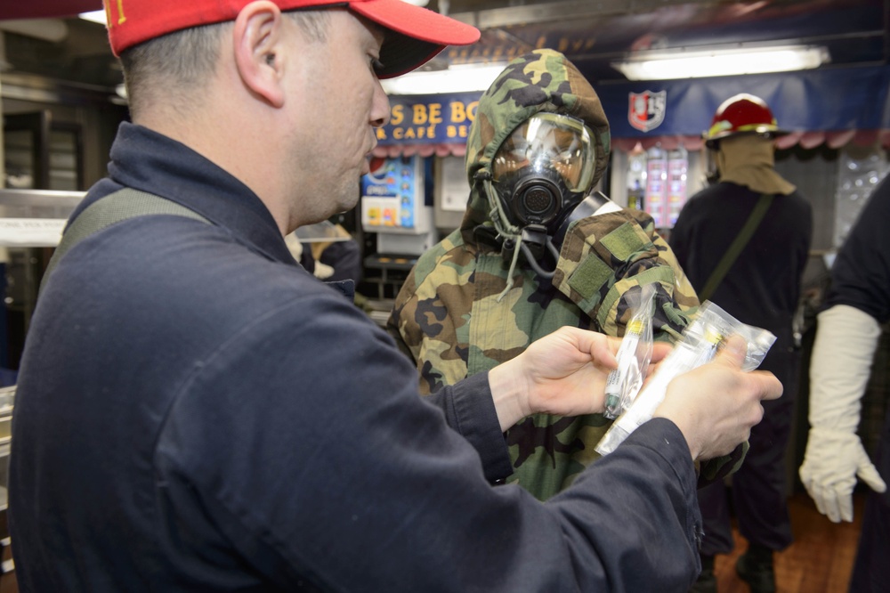 USS Mustin (DDG 89) sailor wears Chemical, Biological and Radiological contamination suit during General Quarters