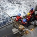 USS Mustin (DDG 89) Sailors prepare to receive fuel during a replenishment-at-sea (RAS) with USNS Matthew Perry (T-AKE-9)