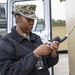 Navy Expeditionary Combat Command (NECC), tests an Iridium satellite phone