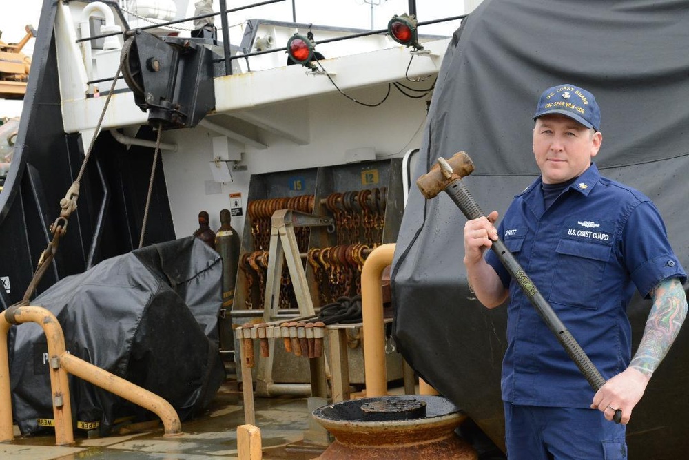 Petty Officer 1st Class Kevin Spratt Displays Hammer Hook Invention