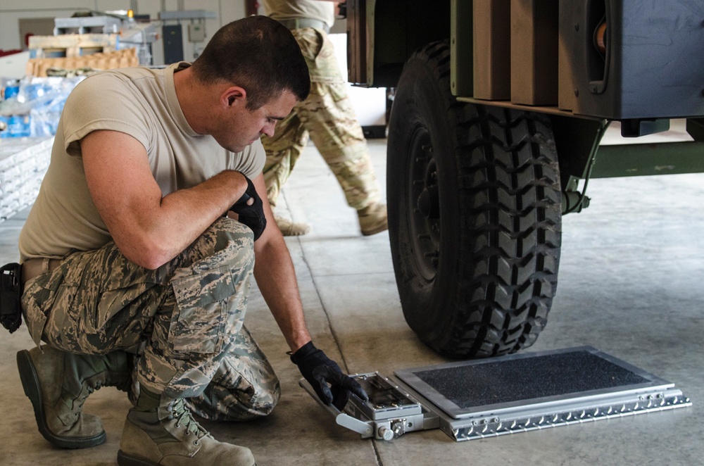 Army and Air Guardsmen work together on hurricane supply logistics