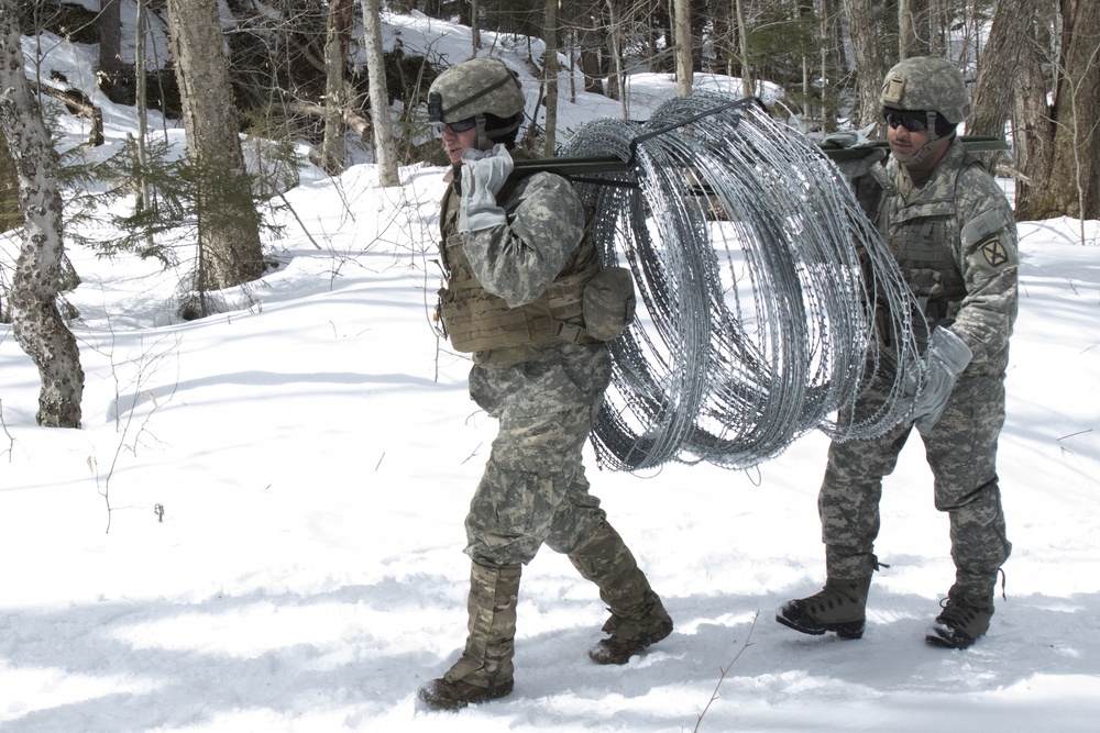 Soldiers Move Concertina Wire