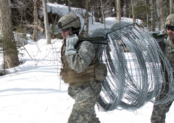 Soldiers Move Concertina Wire