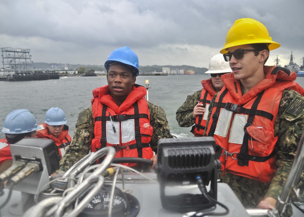 USS Emory S. Land Sailors operate rigid-hull inflatable boat during a training evolution