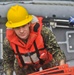 USS Emory S. Land Sailor boards ship after training exercise on a rigid-hull inflatable boat