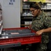 Hospital Corpsman 3rd Class Bryanna Perry searches for supplies in a storeroom during a training evolution in medical department aboard the submarine tender USS Emory S. Land (AS 39)