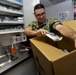 Hospital Corpsman 3rd Class John Nagy puts medical supplies into a box during a training evolution in medical department aboard the submarine tender USS Emory S. Land (AS 39)