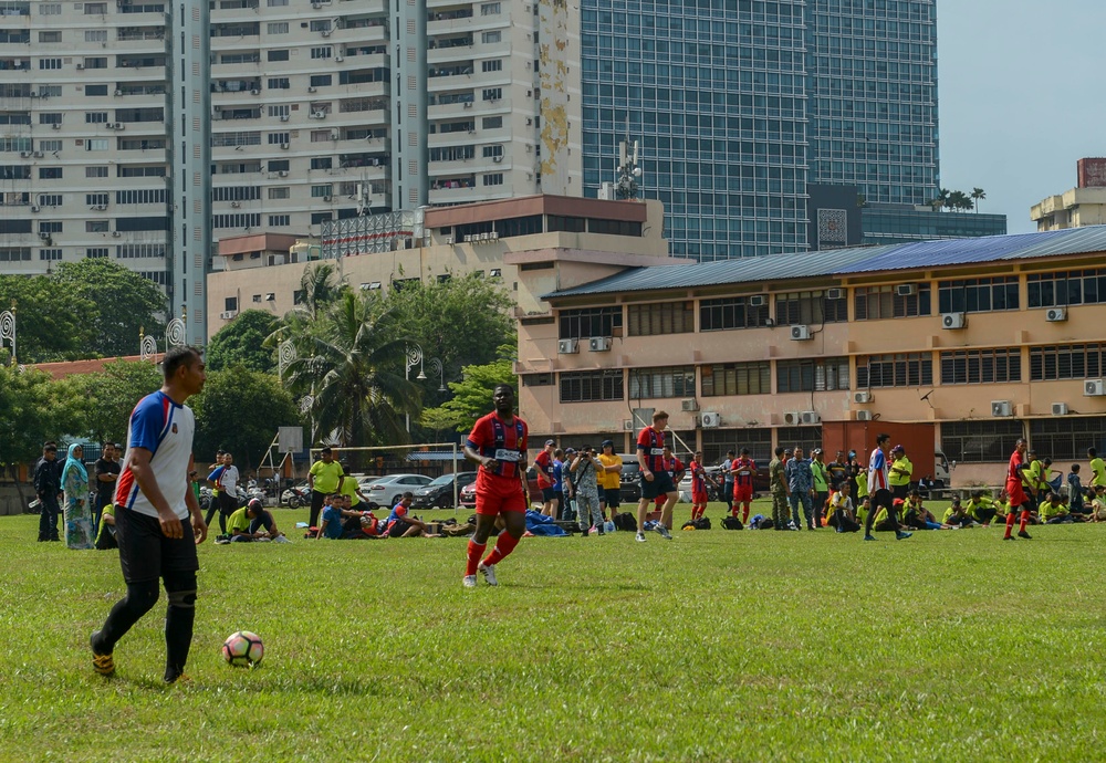 Service Members assigned to USNS Mercy participate in a soccer game in Malaysia during PP18