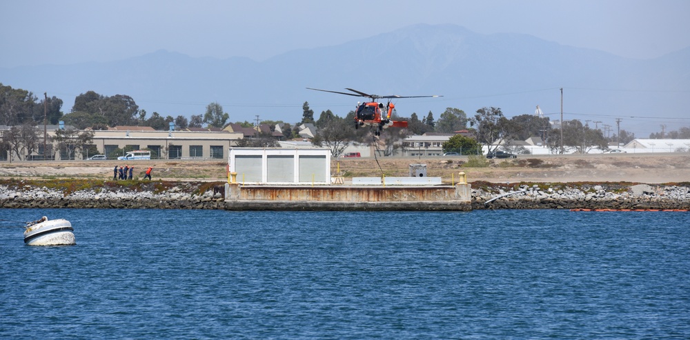 Coast Guard MH-60 helicopter crew transports navigational aid in Seal Beach