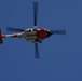 Coast Guard MH-60 Jayhawk helicopter crew transports navigational aid in Seal Beach