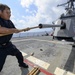 USS Mustin (DDG 89) Sailor performs maintenane on a M160 5-inch gun weapon system