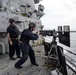 USS Mustin (DDG 89) Commanding Officer fires a M2HB .50 caliber machine gun during a live fire exercise
