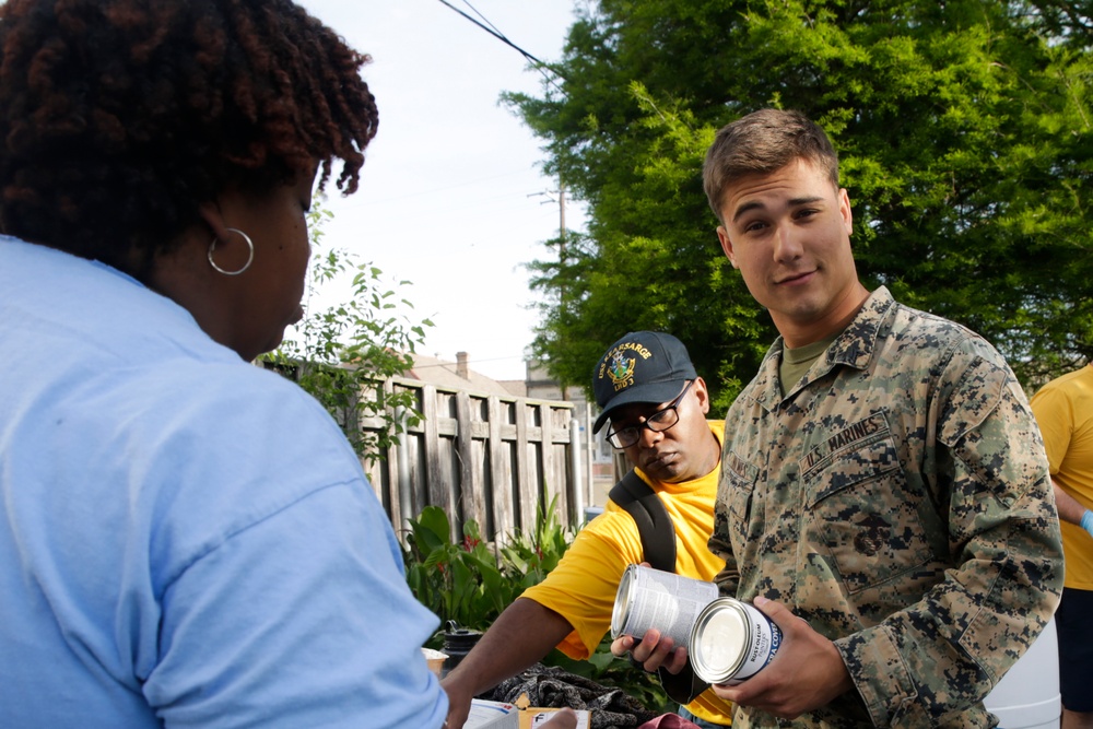 Helping hand: Marines and Sailors partake in a volunteer project