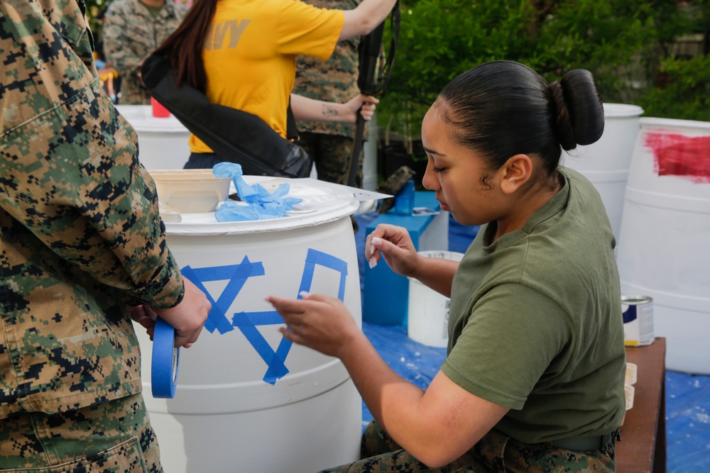 Helping hand: Marines and Sailors partake in a volunteer project