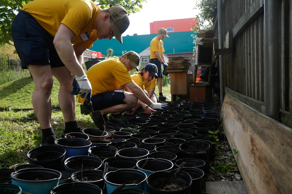 Helping hand: Marines and Sailors partake in a volunteer project