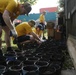 Helping hand: Marines and Sailors partake in a volunteer project