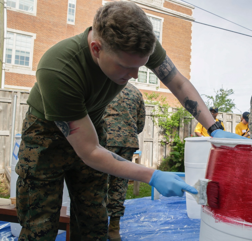 Helping hand: Marines and Sailors partake in a volunteer project