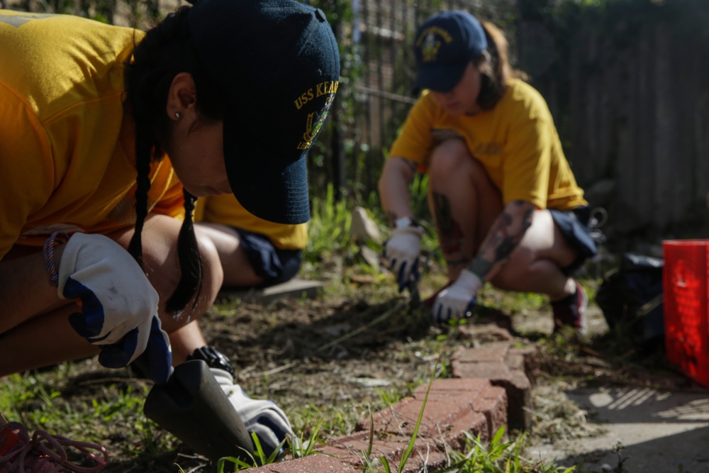 Helping hand: Marines and Sailors partake in a volunteer project