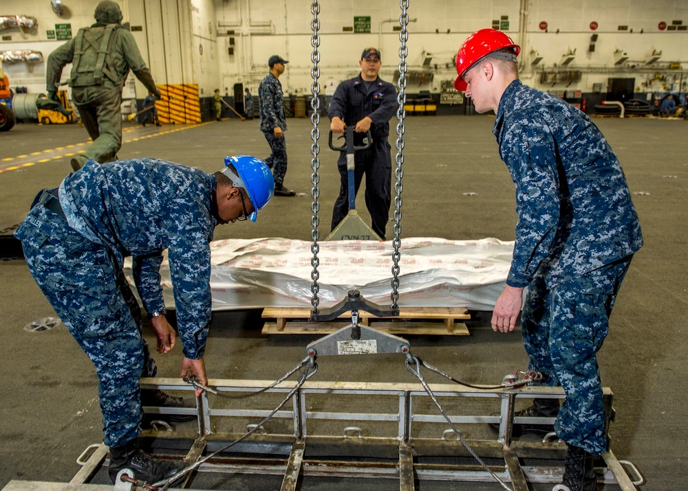 GHWB Sailors move missile launchers