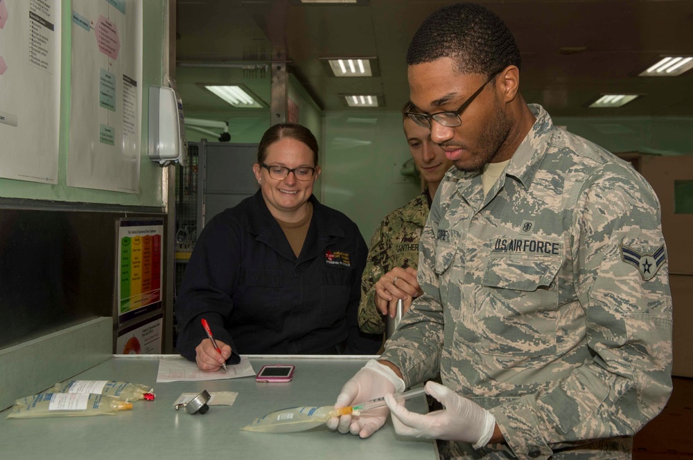 Service Members test IV Bags aboard USNS Mercy