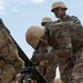 Jordanian soldier checks U.S. mortar alignment during joint training