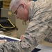 The 53rd Adjutant General of the Pennsylvania National Guard Air Force Maj. Gen. Anthony Carrelli signs a presidential flag being hand-embroidered at DLA Troop Support in Philadelphia April 16.