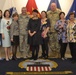 The 53rd Adjutant General of the Pennsylvania National Guard Air Force Maj. Gen. Anthony Carrelli and his senior enlisted advisor, Army Command Sergeant Major Harry Buchanan III pose with the employees of DLA Troop Support’s flag room.