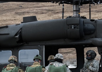 USARAK Soldiers parachute from Black Hawks