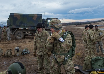 USARAK Soldiers parachute from Black Hawks