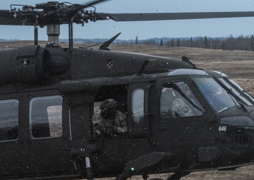USARAK Soldiers parachute from Black Hawks